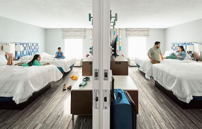 Two guest rooms - parents in one, their kids in the other - separated by a doorway