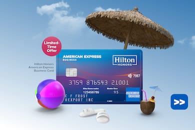 Hilton Honors American Express Business Card floating on a sky background