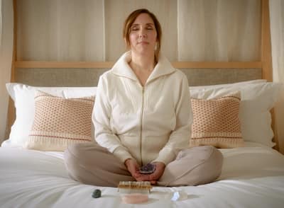 Woman doing a self care routine in hotel bed